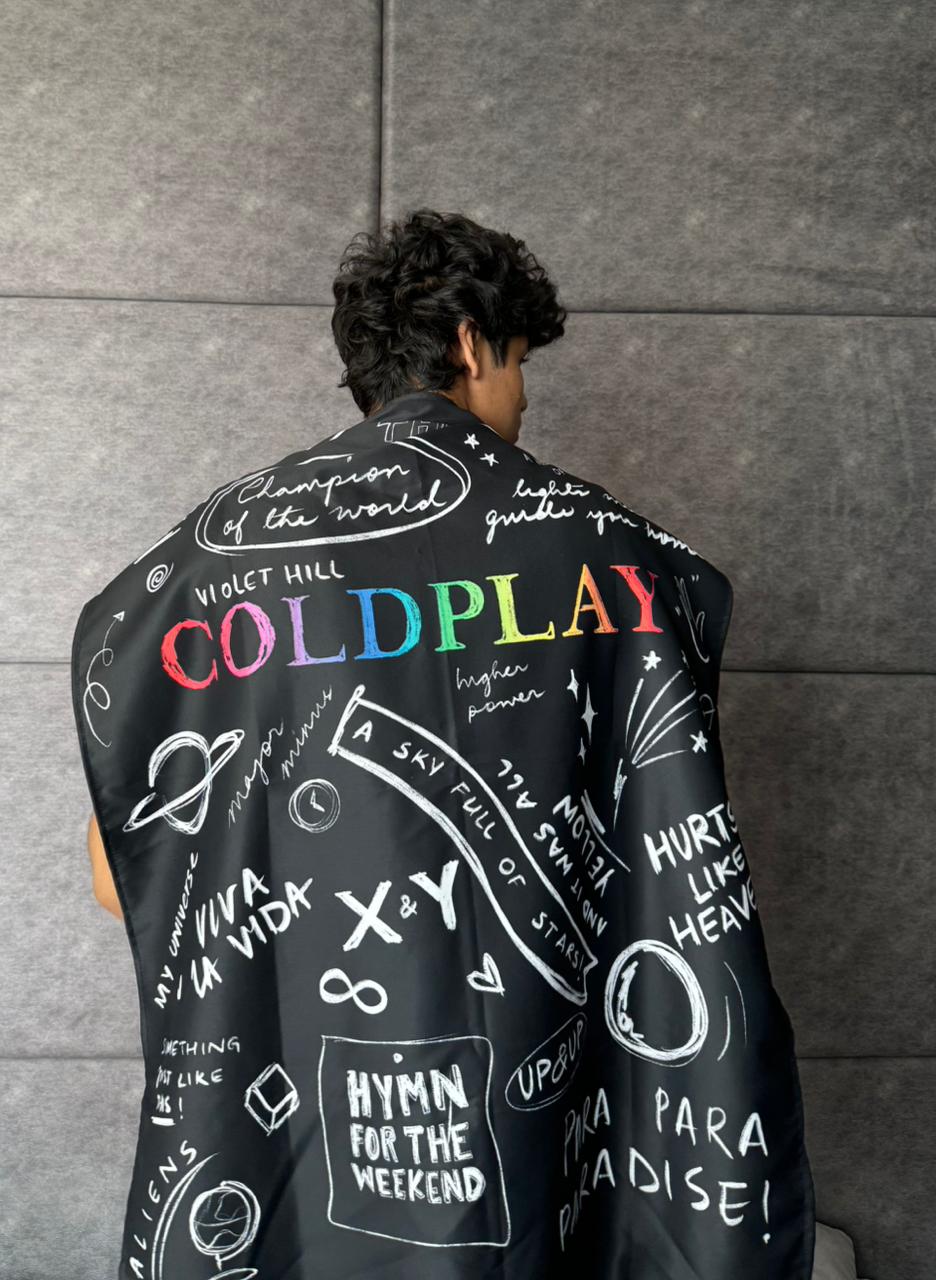 model wearing coldplay design tapestry on his back like a cape