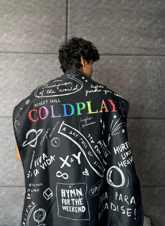 model wearing coldplay design tapestry on his back like a cape